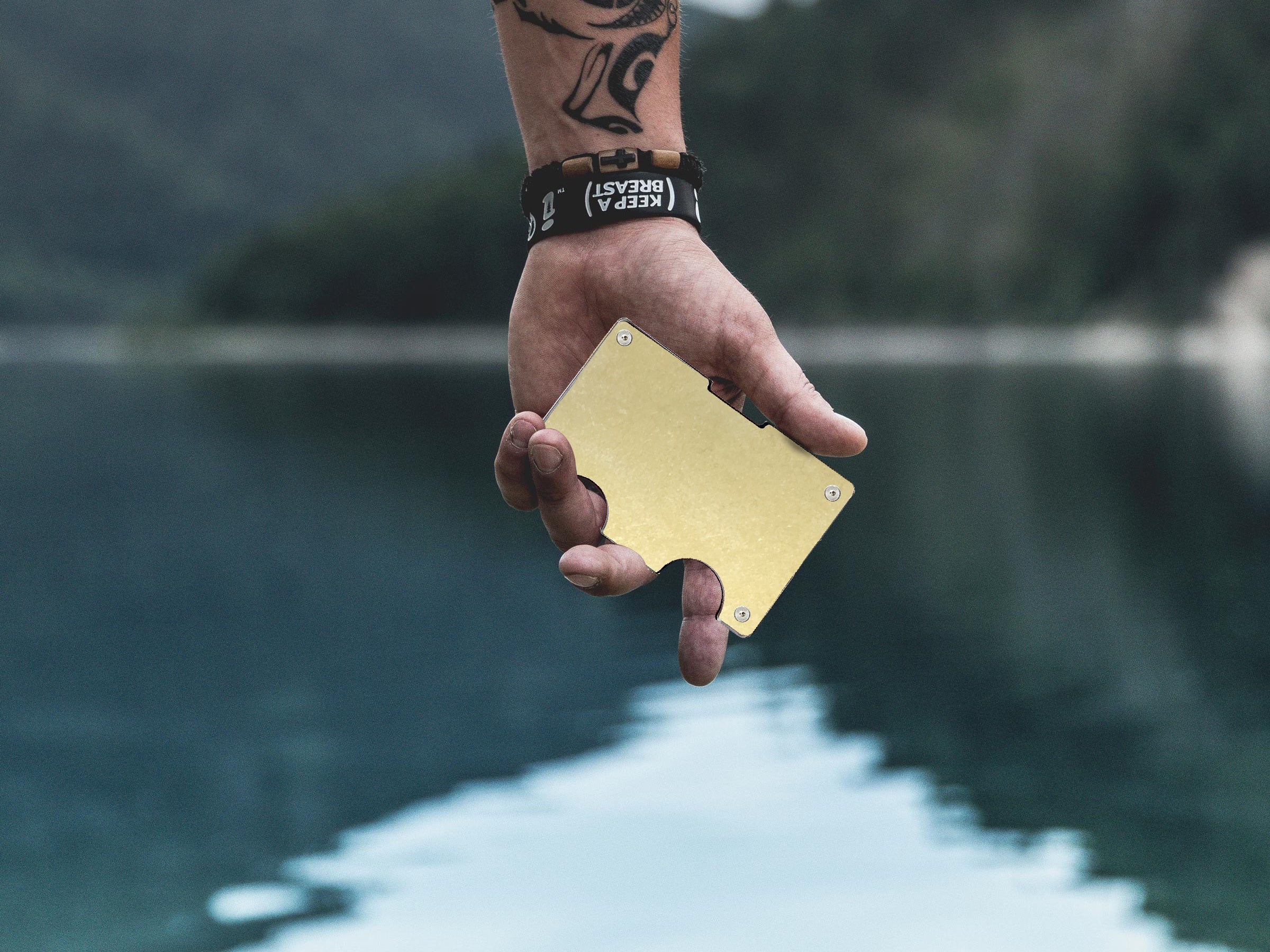 Rift Wallet held in front of lake.